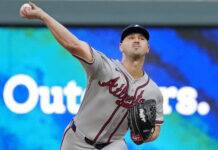 Mahle’s Splitter Must Carry Braves Past Twins Slump Atlanta Braves pitcher mid-pitch, throwing a baseball on the mound with a blue stadium backdrop behind him.